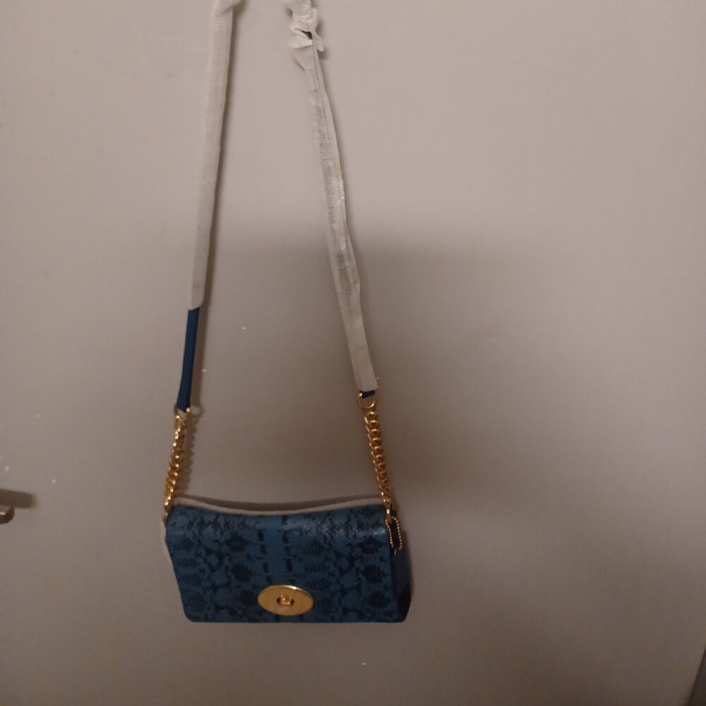 Coach. This is a beautiful cross over or clutch coach bag